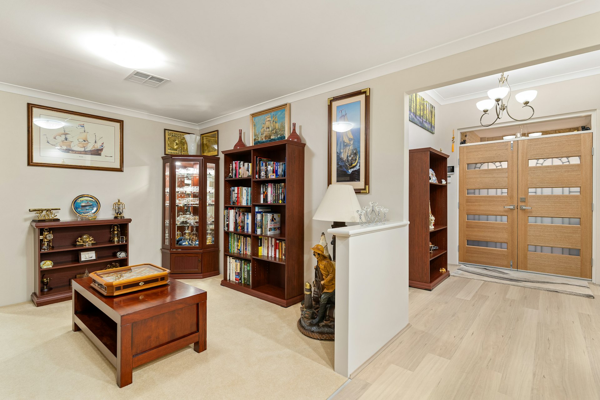 A living room filled with furniture and a book shelf